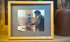 Natural Frame w/ A Print Of A Lady In A Room At A Table